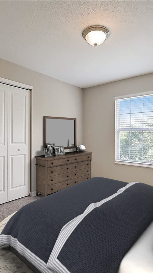 a bedroom with a bed, dresser and nightstand at The Worthington Green
