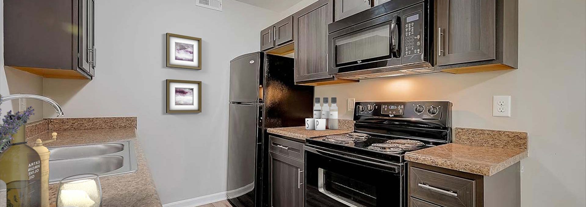 kitchen with black appliances and granite counter tops at The Worthington Green